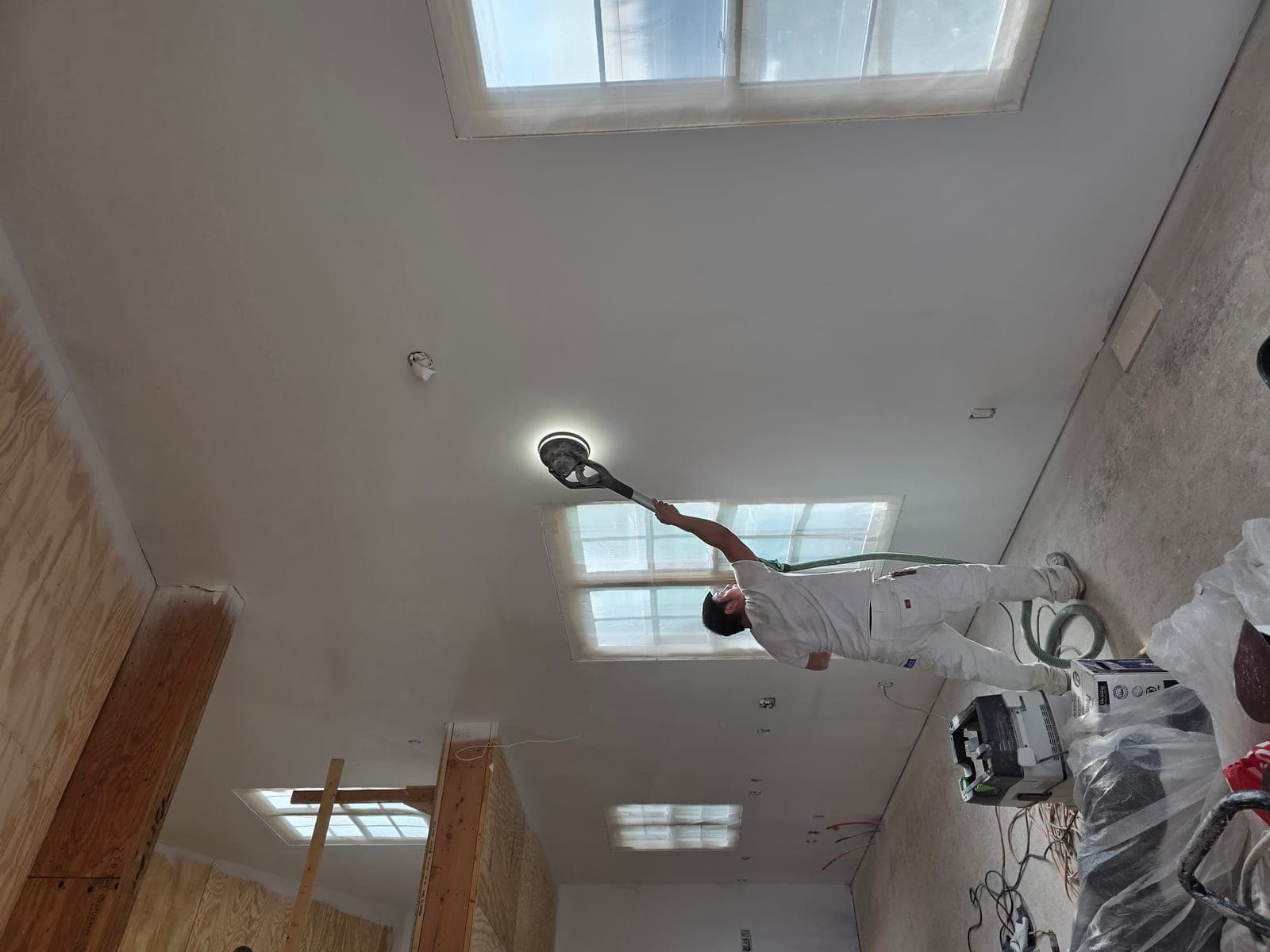 Mission Painting crew member performing Festool HEPA vacuum sanding on interior surfaces